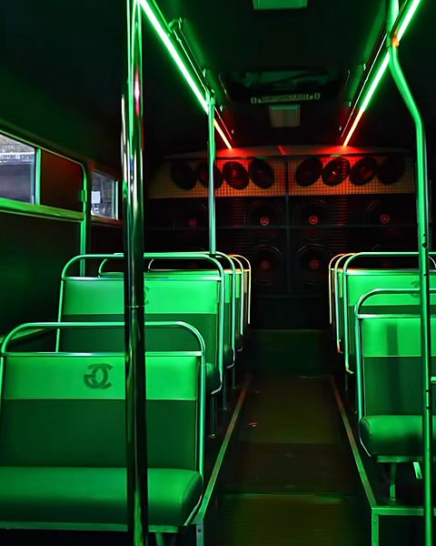 The aisle lit green, looking back towards the speaker wall