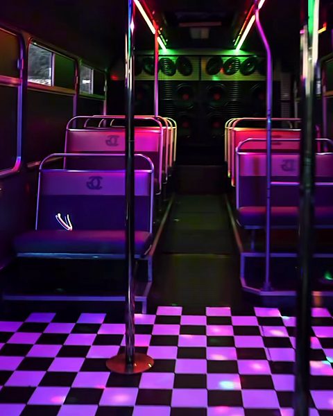 The aisle in pink and purple light, with LED strips along the ceiling and a checkerboard floor